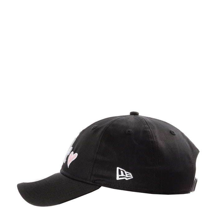 Black baseball cap with small heart emblem and New Era logo on side