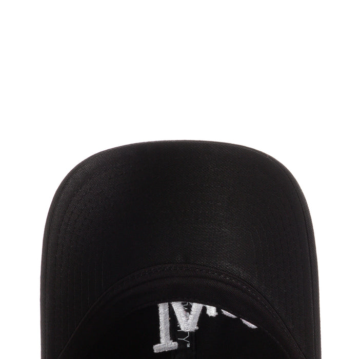 Black cap close-up of brim interior with white printed emblem