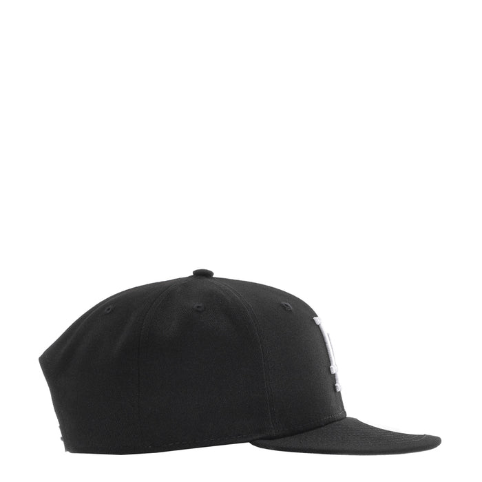 Black baseball cap with curved brim and stitched panels, side view