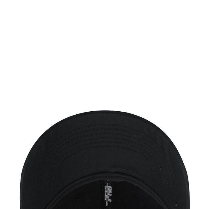Black baseball cap interior close-up with stitched crown and small brand patch