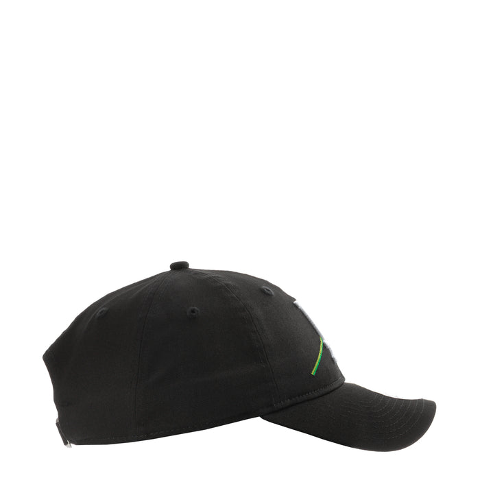 Black baseball cap, side view with small green stitched detail near crown