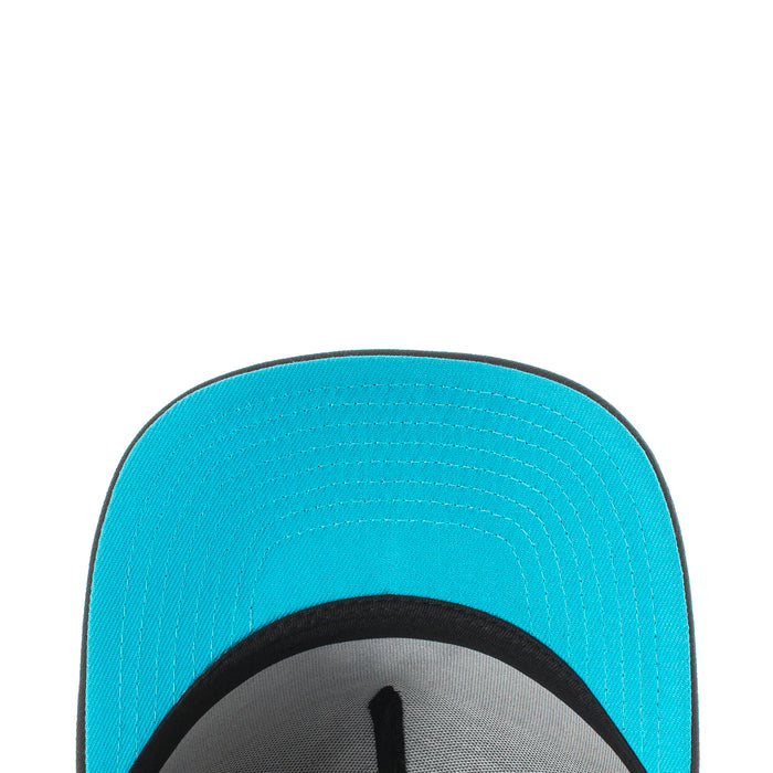 A-frame baseball cap with turquoise underside brim and stitched panel
