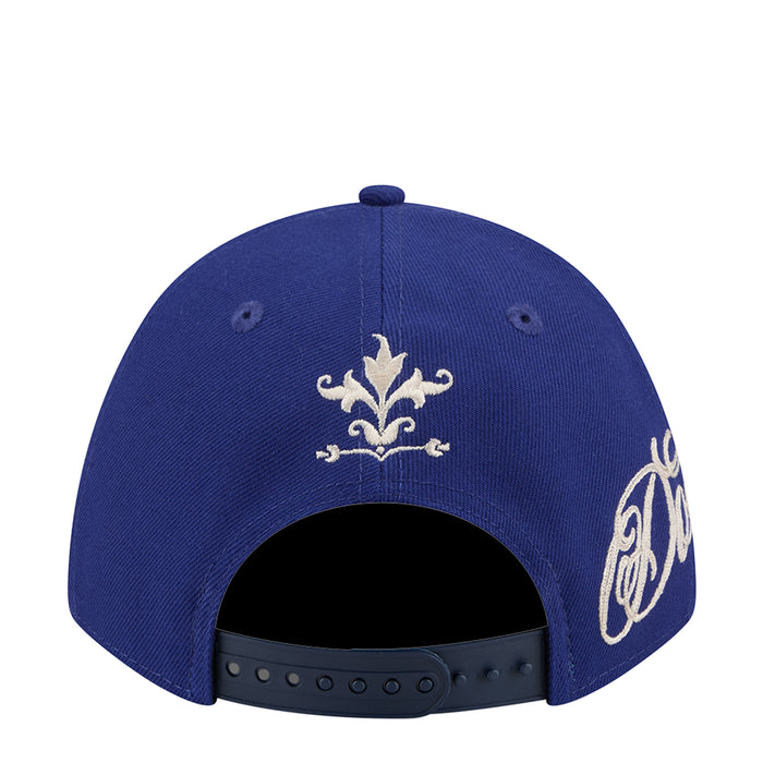 Blue baseball cap top view with embroidered fleur-de-lis and script side graphics