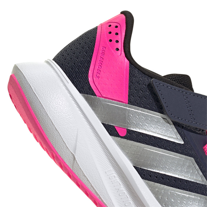 Close-up of navy kids shoe tongue with pink padding, silver stripe detail, white sole