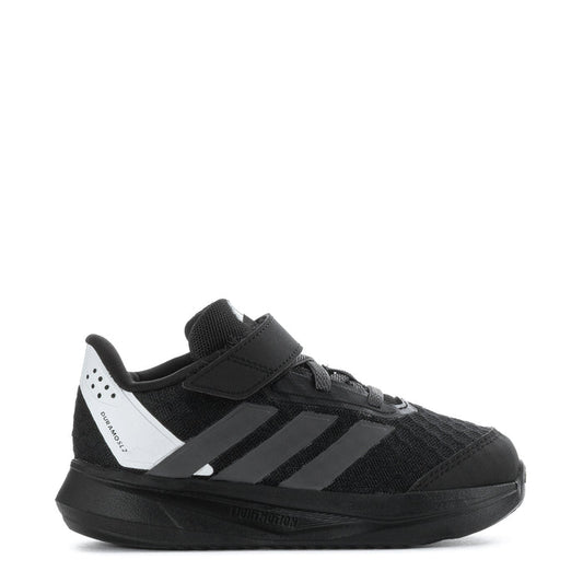 Kids black low-top sneaker with hook-and-loop strap, white side stripes, cushioned sole
