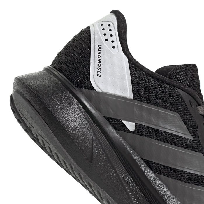 Youth running shoe tongue and side close-up, white label and gray stripe detail
