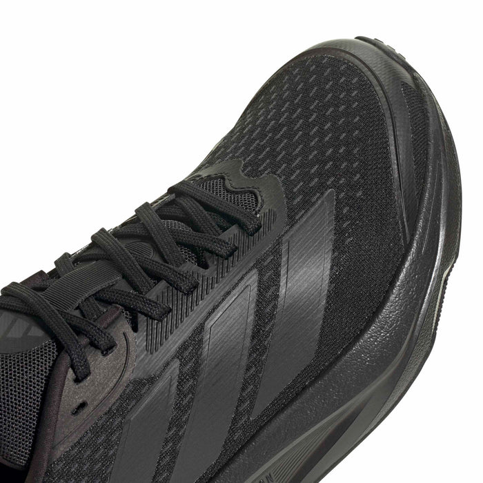 Black running shoe close-up: lace-up mesh upper with side panel texture