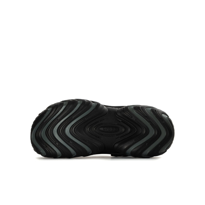 Black youth clog sole view with textured tread and wavy pattern