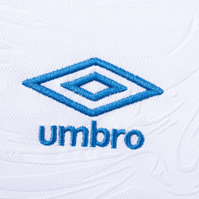 Close-up of Umbro logo on white soccer jersey fabric