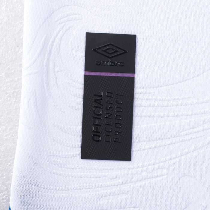 Close-up of Umbro neck label on white soccer jersey