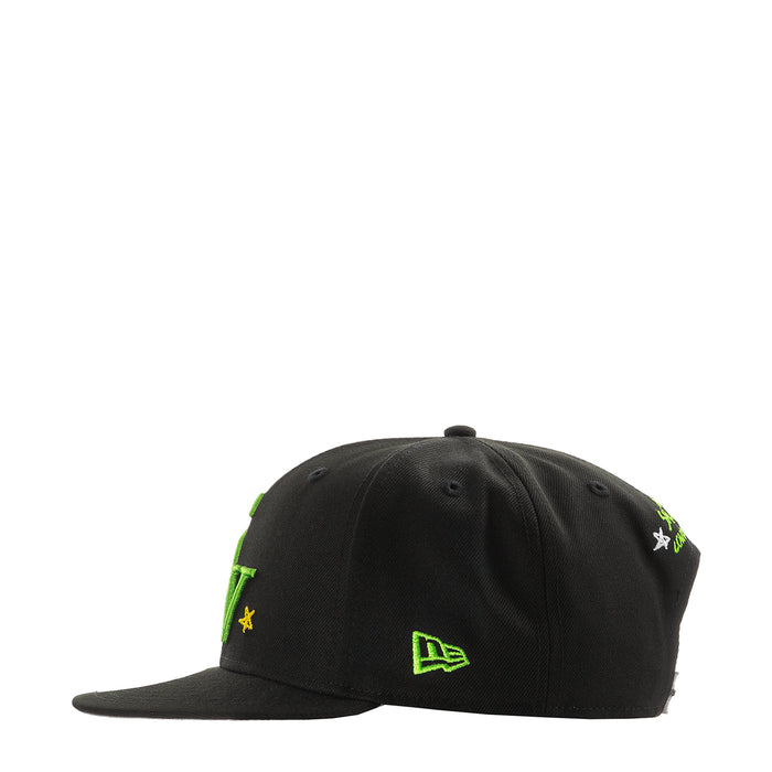Black baseball cap with green symbols and small yellow star accents