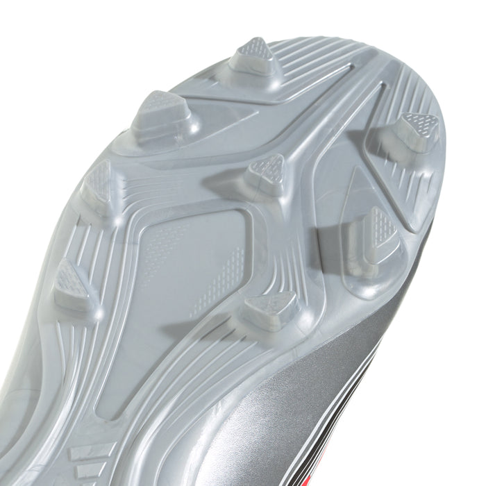 Kids soccer cleat outsole close-up, molded studs on white/gray rubber sole