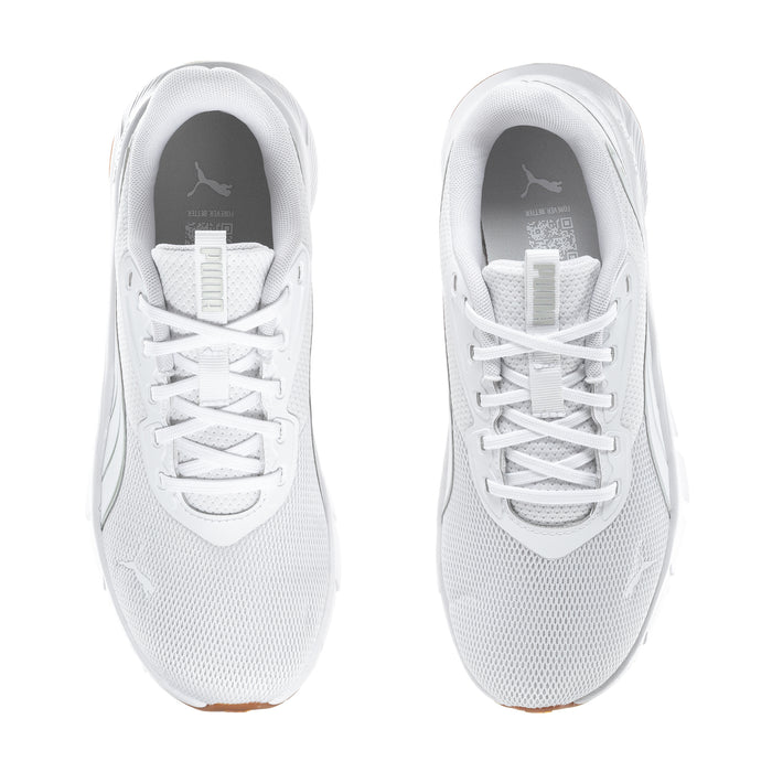 White lace-up running shoes for women, tongue and eyelets close-up, gum sole