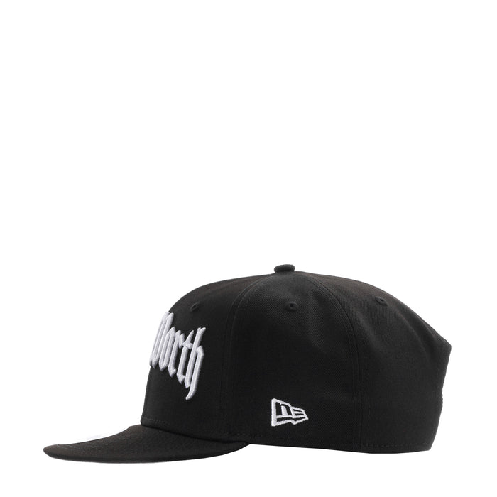 Black baseball cap with white logo and New Era flag patch