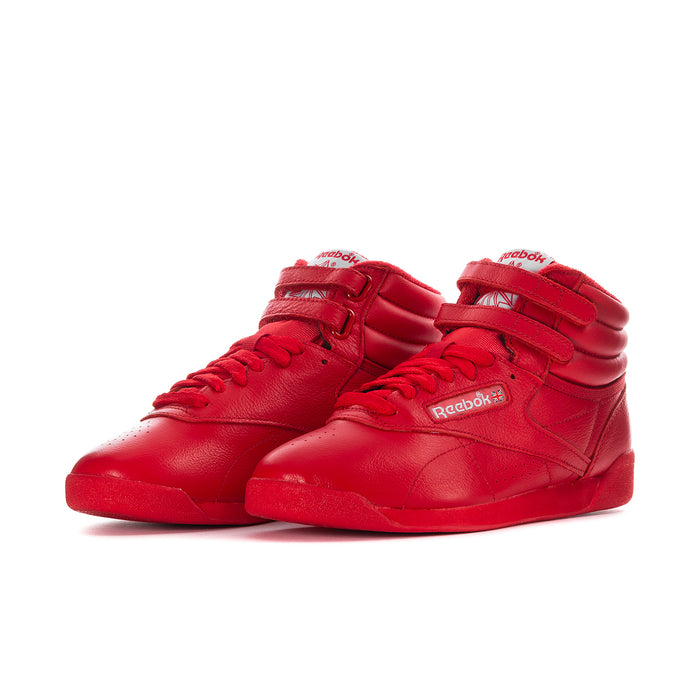 Red high-top sneakers with two straps, lace-up front, and Reebok logo on side