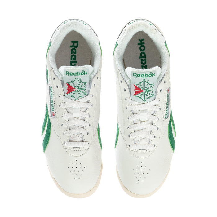Pair of white Reebok low-top sneakers with green heel tabs and white laces