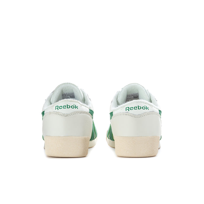 Back view of white Reebok sneakers with green heel tabs and tan outsole