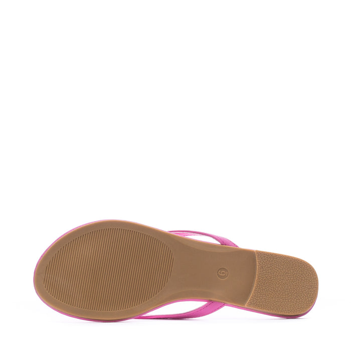 Women's fuchsia flip-flop sandals shown from outsole with textured tread