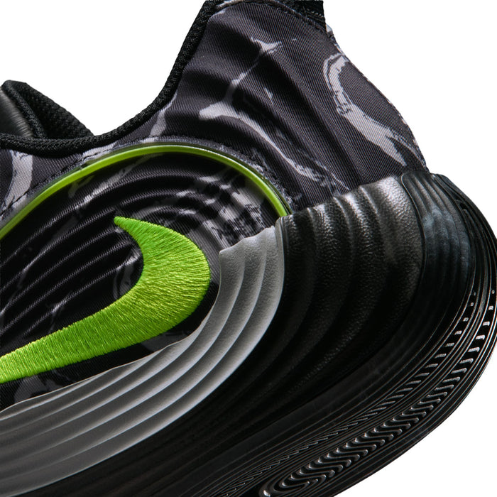 Close-up of black mens running shoe side with volt green logo and ridged midsole