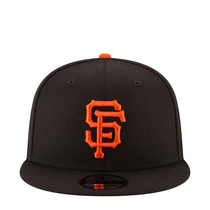 Black baseball cap with orange SF logo on front and orange top button