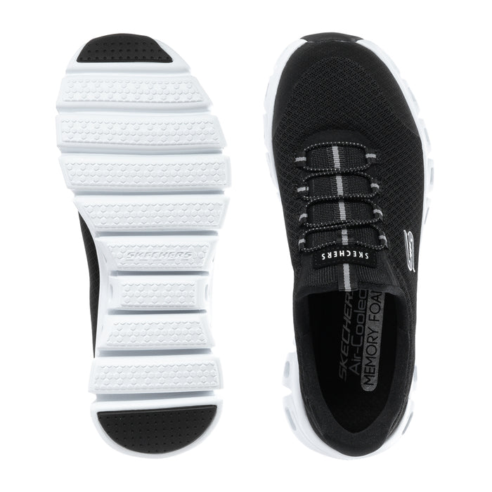 Black and white women's sneaker outsole with tread and lace-up upper view