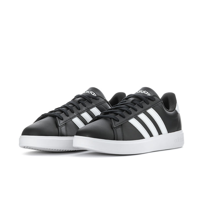 Pair of men's black adidas sneakers with white stripes and white rubber sole