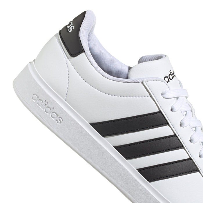 Men's white low-top sneakers with black stripe panel and adidas side logo