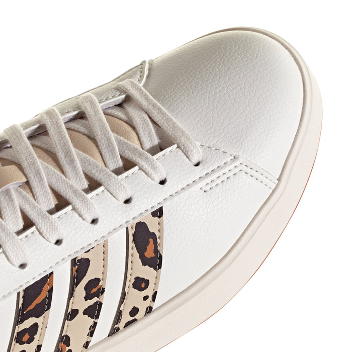 White adidas sneaker close-up: lace area with leopard stripe side panels