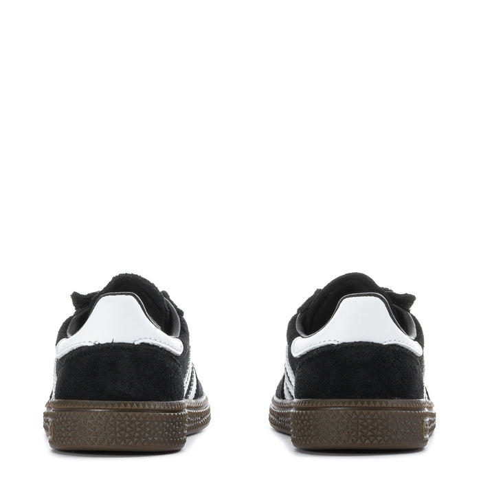 Kids black sneakers rear view with white heel collar and gum-colored textured outsole.