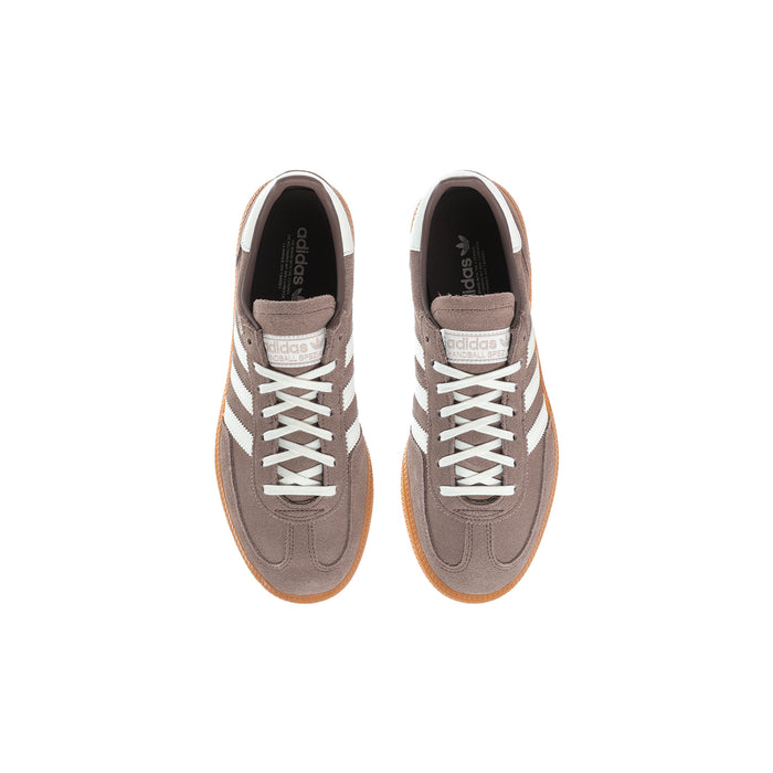 Youth sneakers pair, brown uppers with cream laces and orange gum soles.
