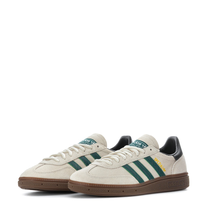 Youth sneakers pair, off-white uppers with green stripes and dark heel panels