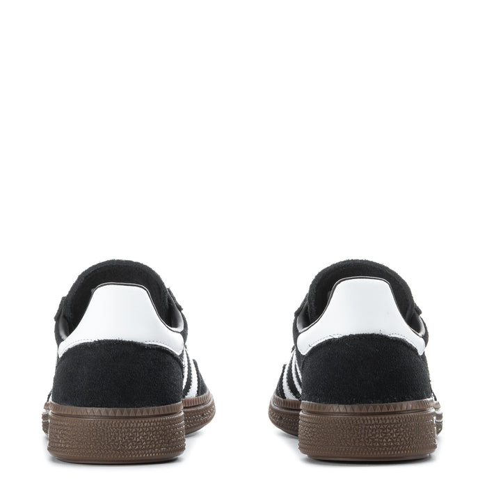 Youth black adidas sneakers with white heel tab and gum rubber sole at back