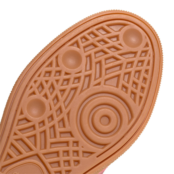 Youth sneaker outsole close-up with circular traction icons and grid texture
