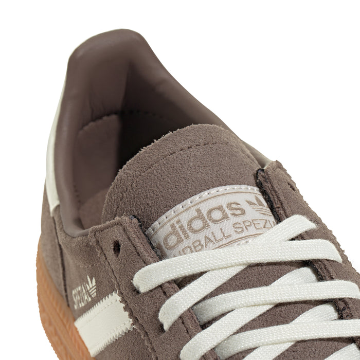 Youth sneaker heel and tongue, brown suede with adidas logo and cream laces.