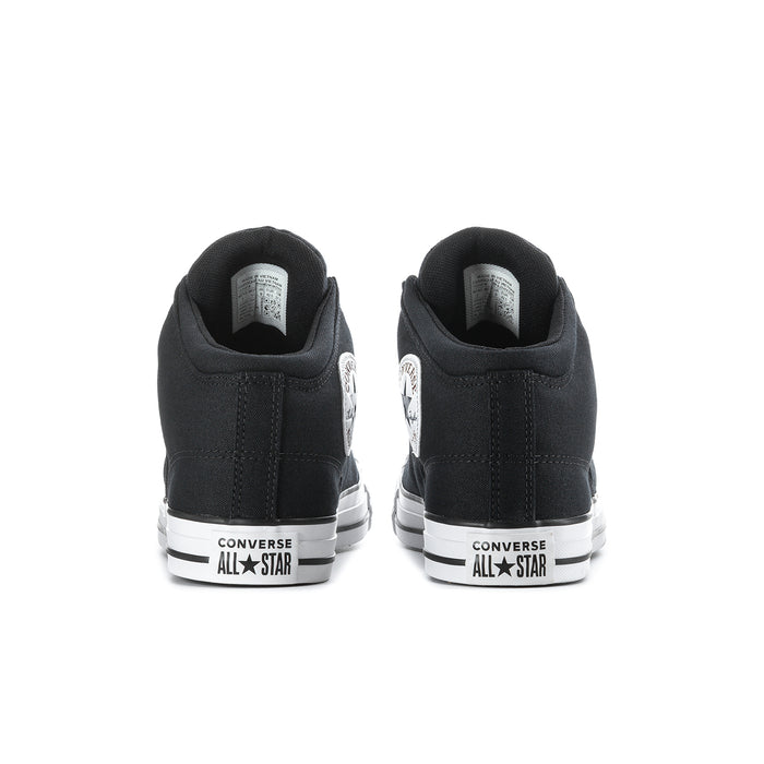 Men's black mid-top sneakers showing white heel branding and flat rubber outsole
