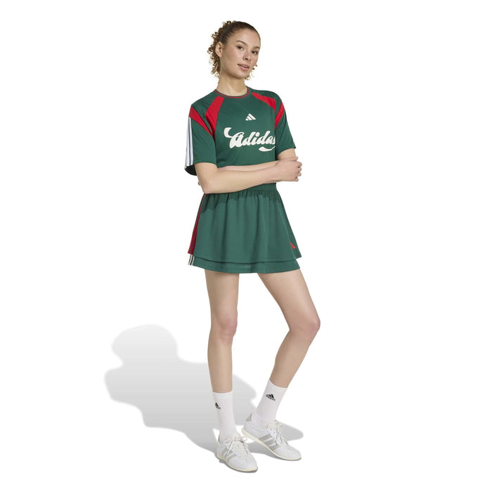 Women's dark green athletic mini skirt with red side bands and elastic waistband