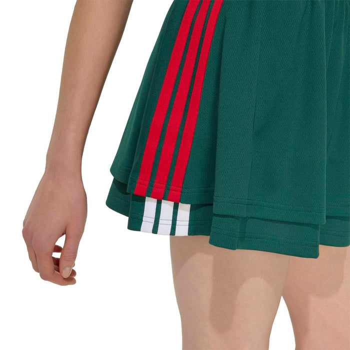Dark green skirt hem with red side stripes and white triple stripe detail