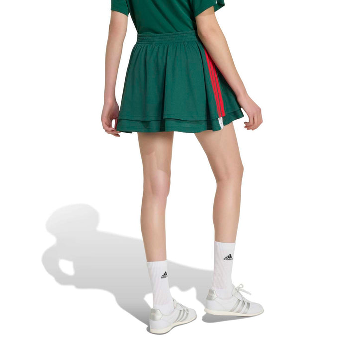 Women's dark green athletic mini skirt with layered hem and red side piping