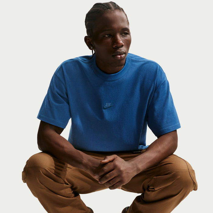 Court blue men’s crewneck T-shirt with small chest logo, worn