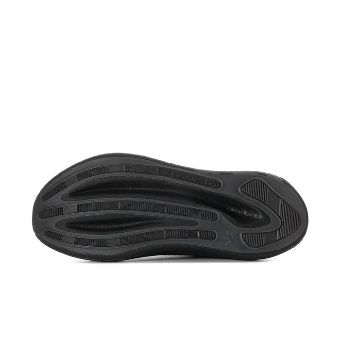 Men's black sneaker outsole with tread pattern and molded traction pods