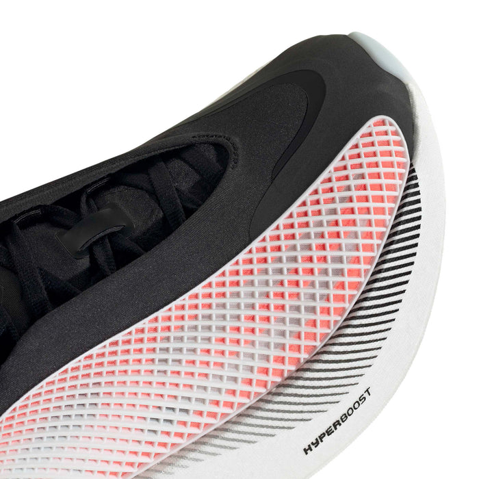 Close-up of men's sneaker with red textured grid panel, black stripes, and white sole