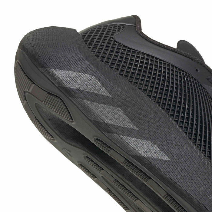 Close-up of men's black sneaker outsole edge with vented side tread
