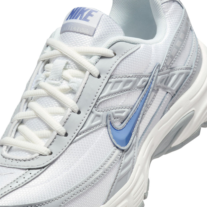 Close-up of women’s white lace-up running shoe with blue Swoosh and stitched overlay details.
