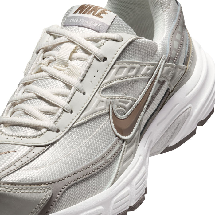 Nike women's running shoes, close-up of laces, tongue label, and side swoosh