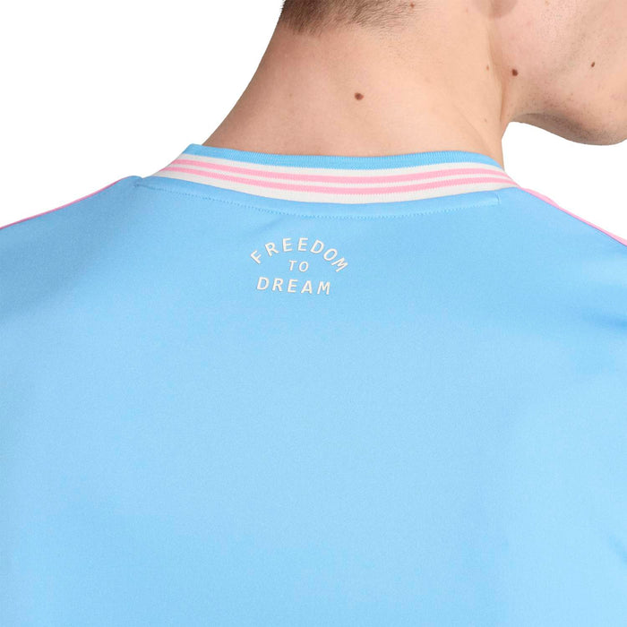 Men's light blue soccer jersey back collar text: “FREEDOM TO DREAM”