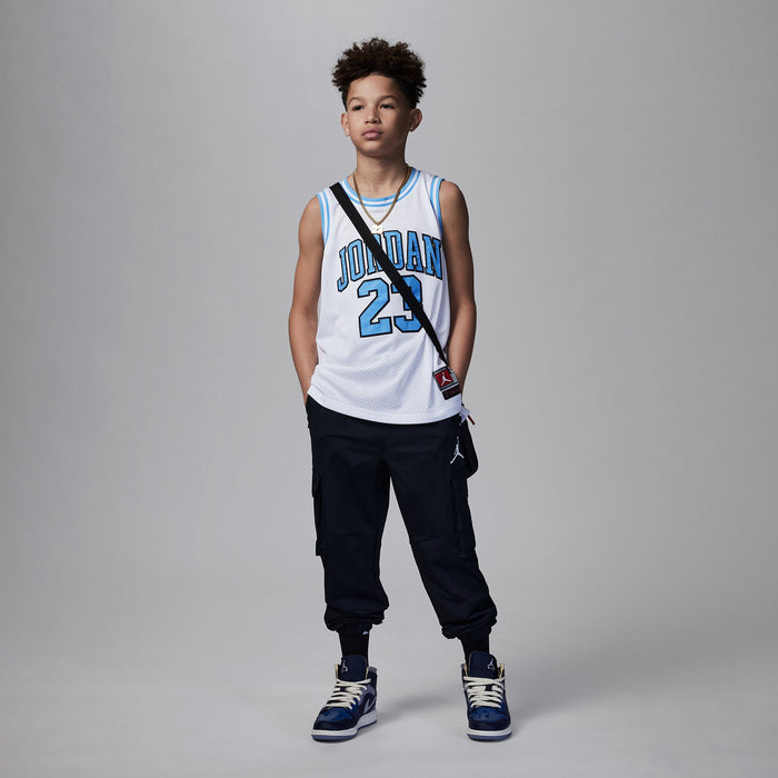White youth basketball jersey with Jordan 23 front print and light blue trim