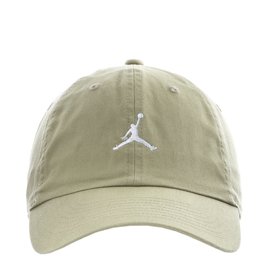 Unstructured washed khaki baseball cap with white Jumpman logo and curved brim.