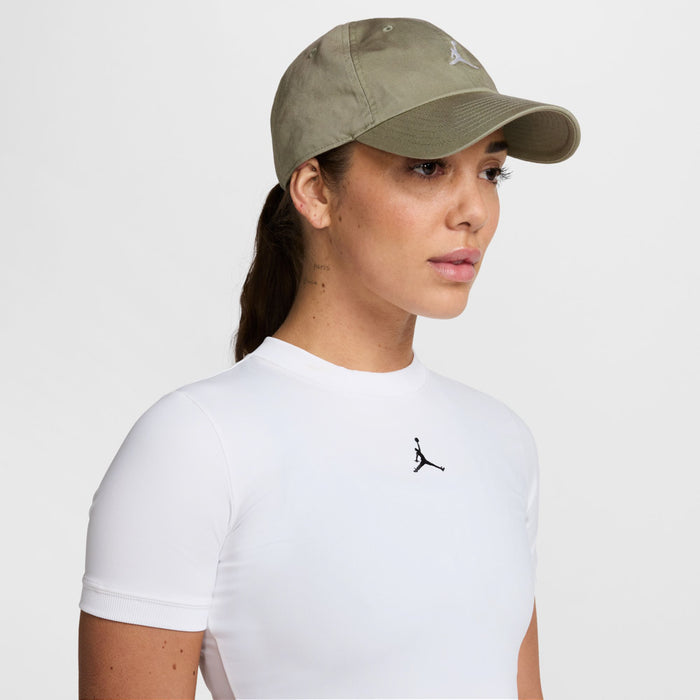 Washed khaki unstructured cap with curved brim and small white Jumpman logo on front.