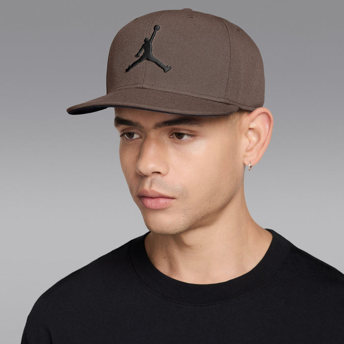 Taupe snapback cap with black Jumpman logo and curved brim