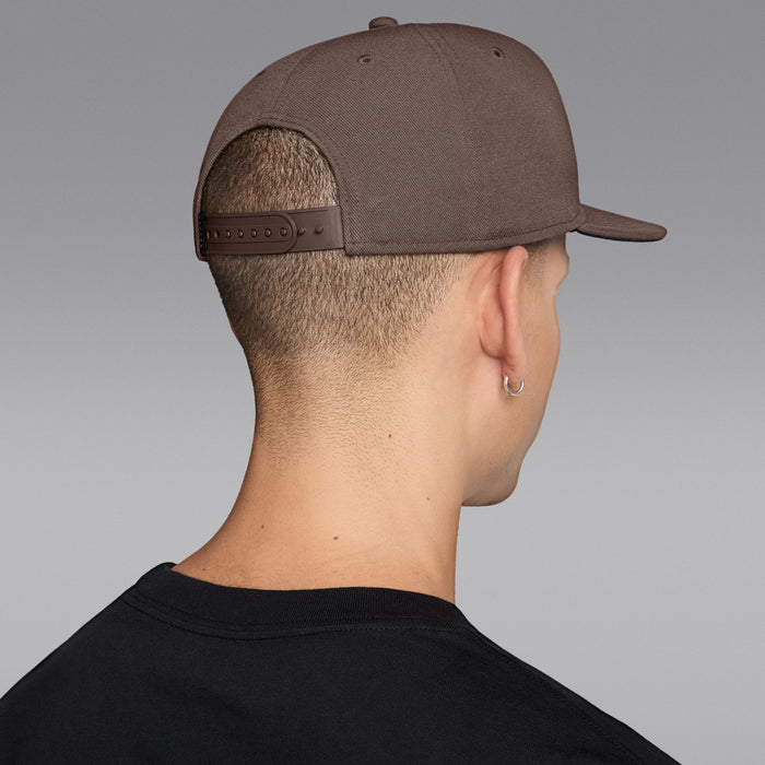 Taupe snapback cap back with adjustable leather-look strap and metal eyelets